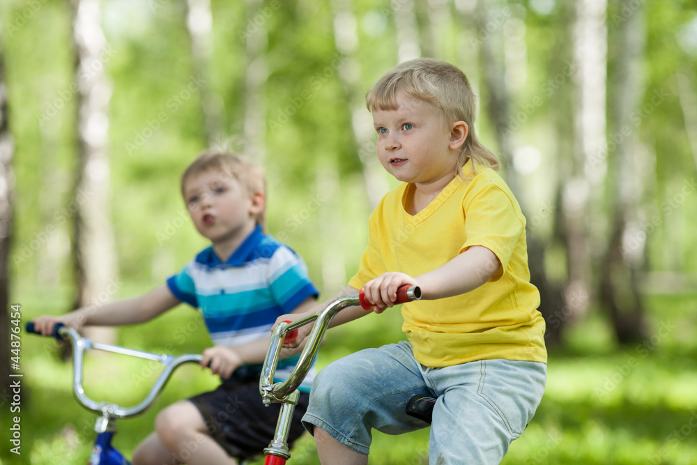 little children riding their bikes