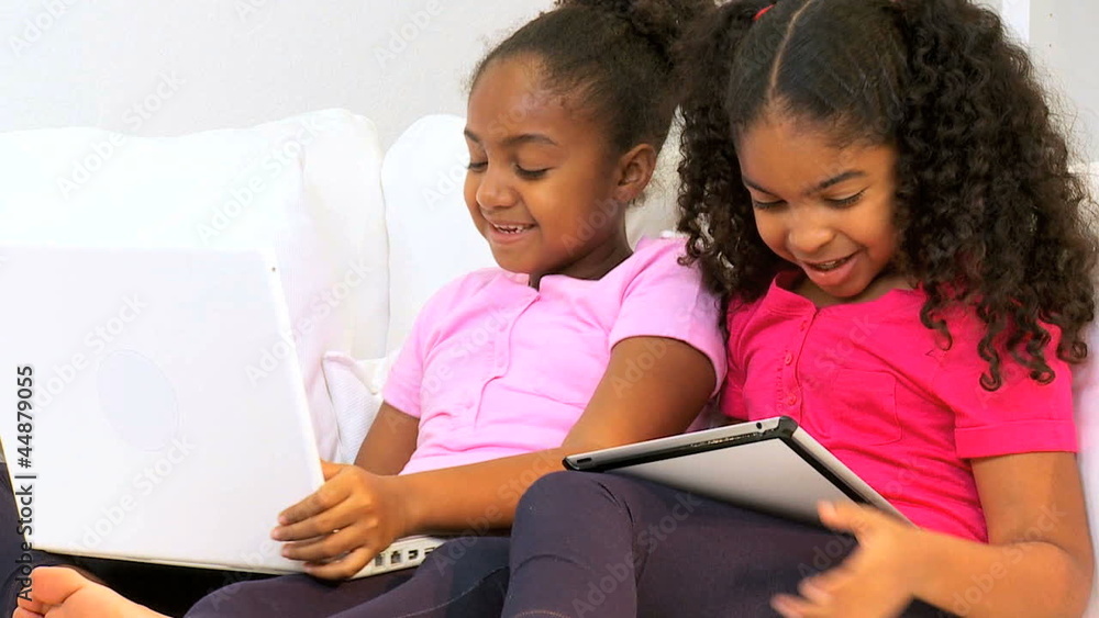 Happy Ethnic Sisters Playing Wireless Technology Happy Ethnic Sisters Playing Wireless Technology