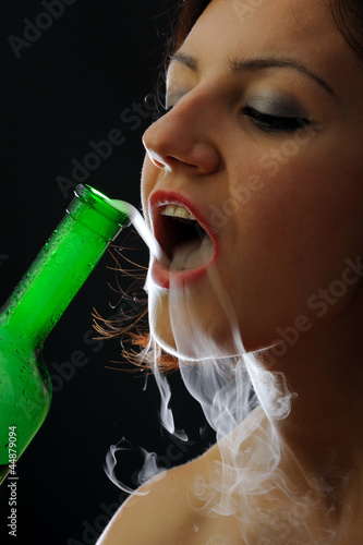 Beautiful fortuneteller in smoke with color glass bottle photo