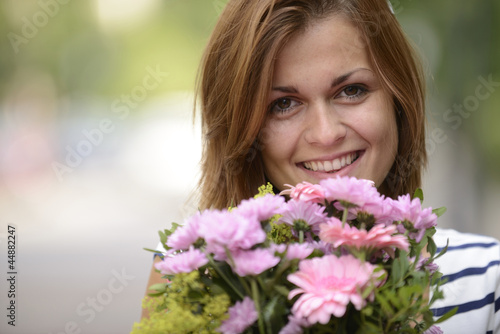 woman with bouquet of flowers © mangostock