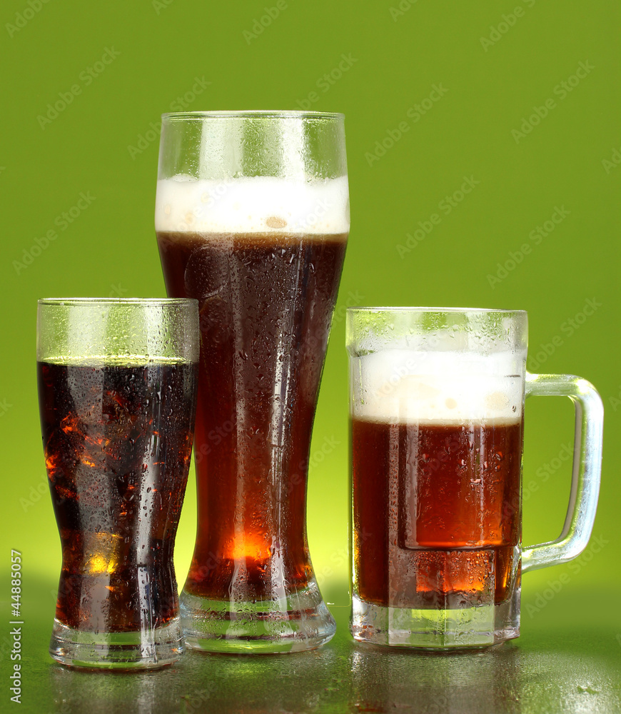 refreshments - beer, cola and kvass on green background refreshments - beer, cola and kvass on green background