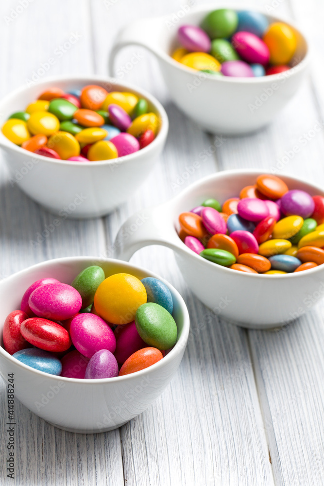 colored candy in white bowl colored candy in white bowl