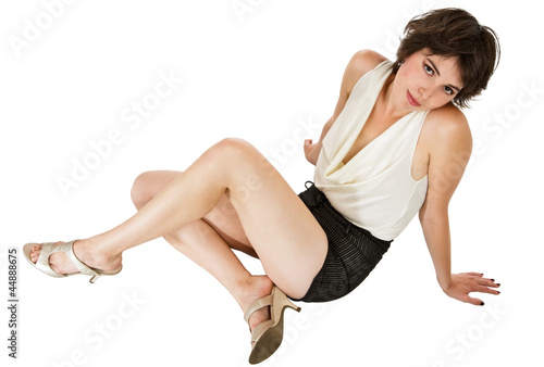 Glamorous dark-haired young woman seated on floor leaning back © Jeanne McRight