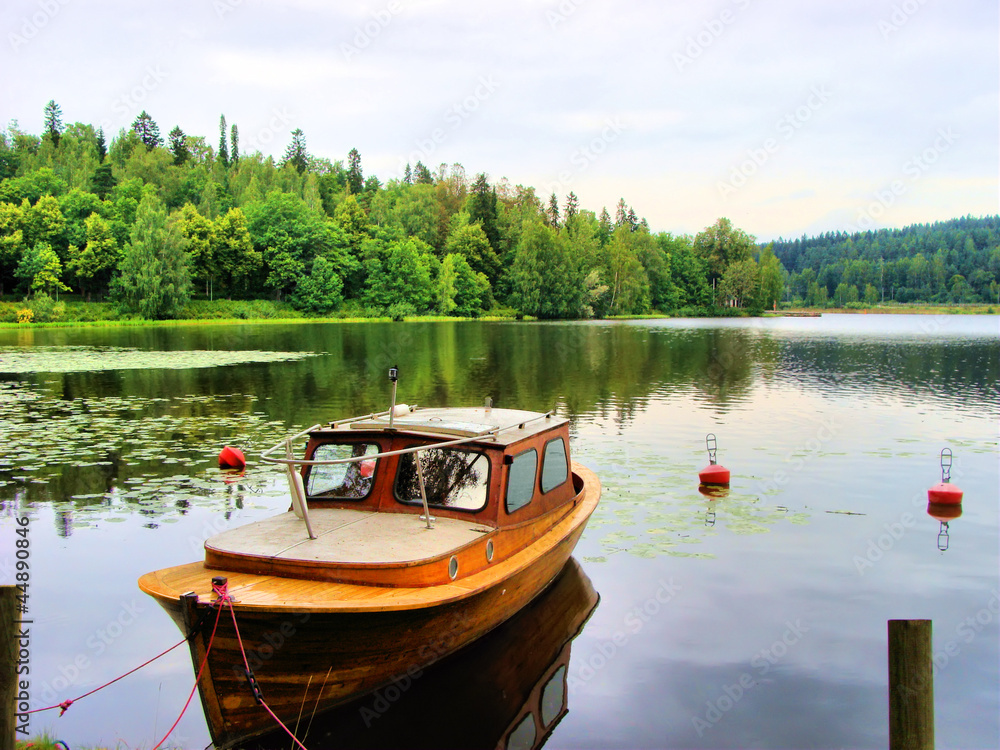 Tranquil Finnish landscape: single boat in a calm lake
