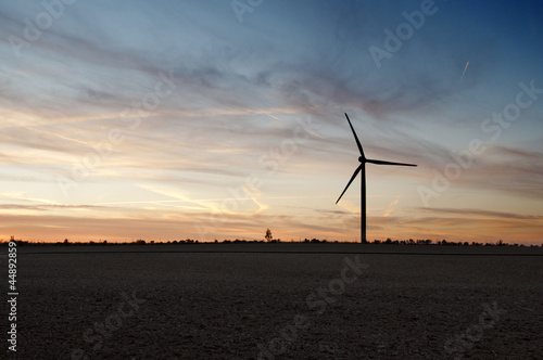 Silhouette of windmill generator at dusk