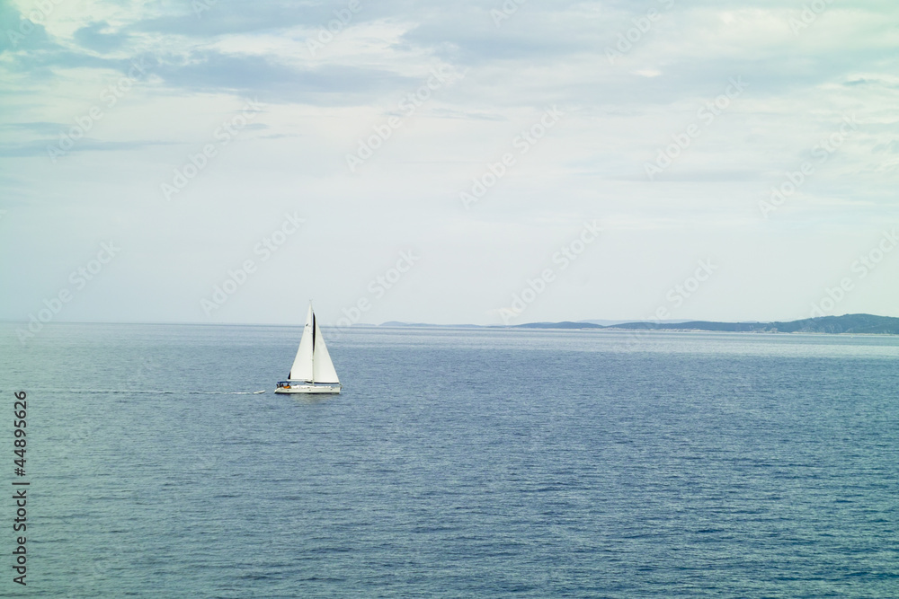 A small sailing yacht in the sea