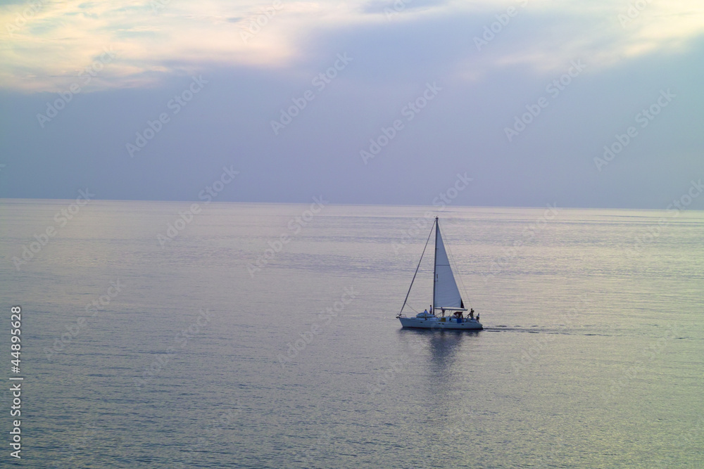 A small sailing yacht in the sea