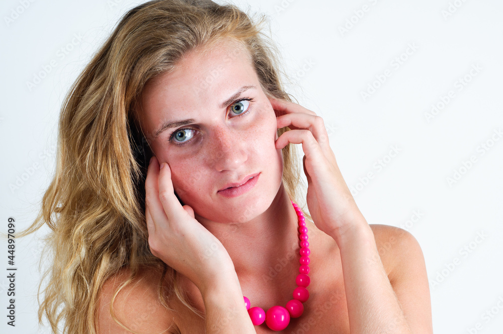 Portrait of young beautiful woman with hands on cheek and ear Portrait of young beautiful woman with hands on cheek and ear