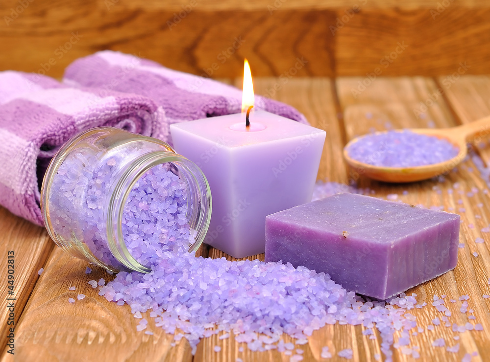 Purple sea salt and a burning candle Purple sea salt and a burning candle