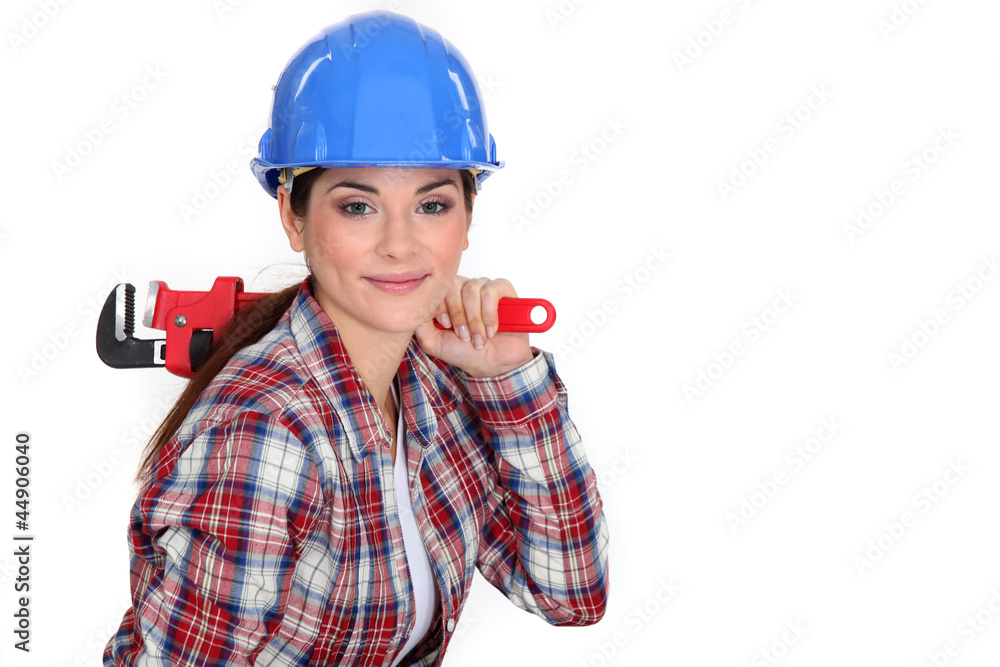 Fototapeta premium Tradeswoman holding a pipe wrench