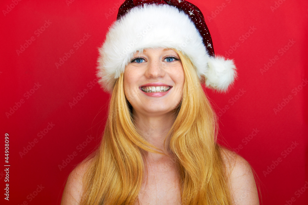 beautiful blonde girl wearing a christmas hat is smiling beautiful blonde girl wearing a christmas hat is smiling
