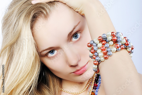 Portrait of the beautiful girl in costume jewellery