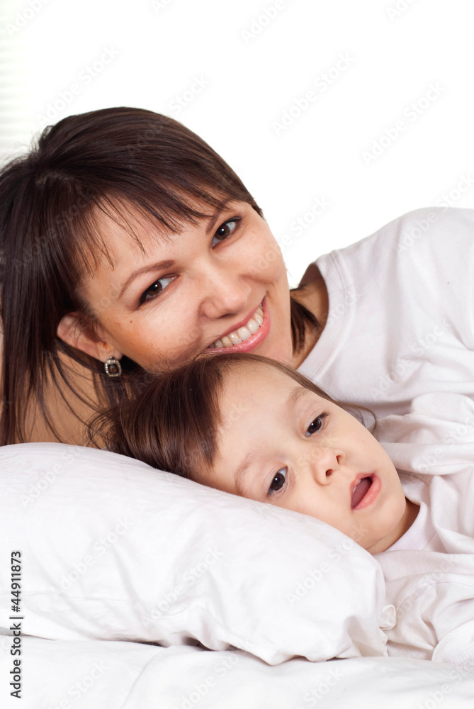A beautiful pretty Caucasian mother with her daughter lying A beautiful pretty Caucasian mother with her daughter lying