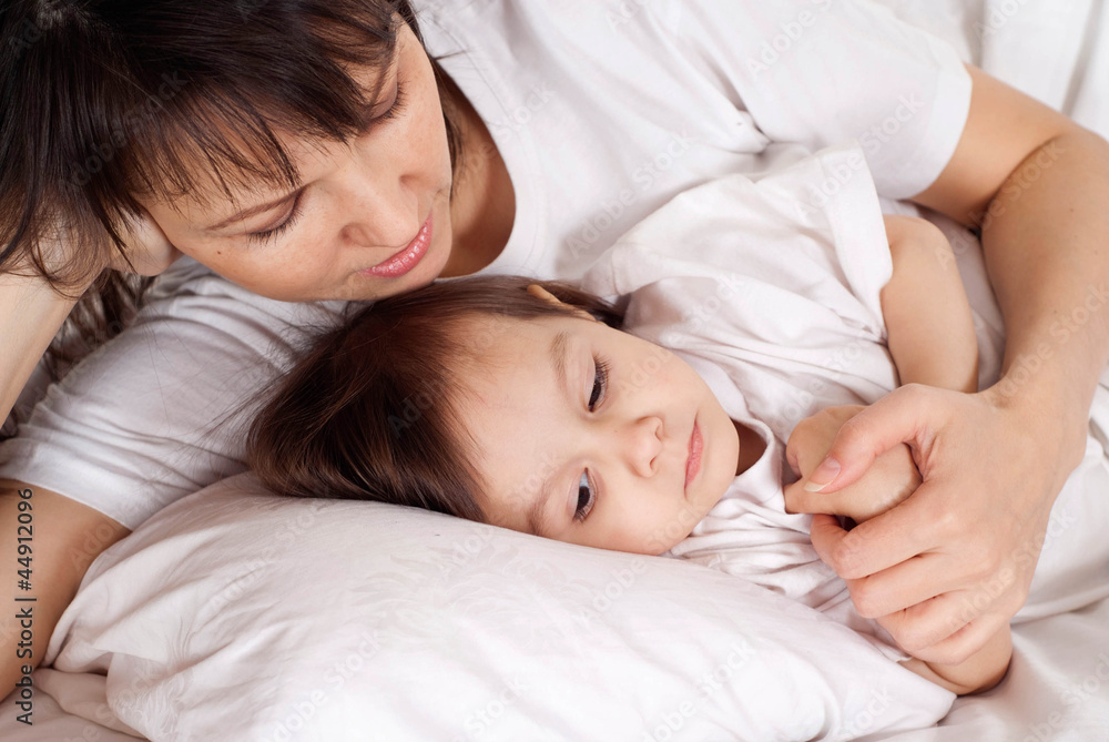 A beautiful Caucasian mummy with her daughter lying with a penci A beautiful Caucasian mummy with her daughter lying with a penci