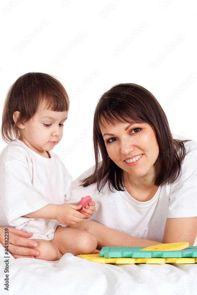 A smile Caucasian mother with her daughter play with a mat A smile Caucasian mother with her daughter play with a mat