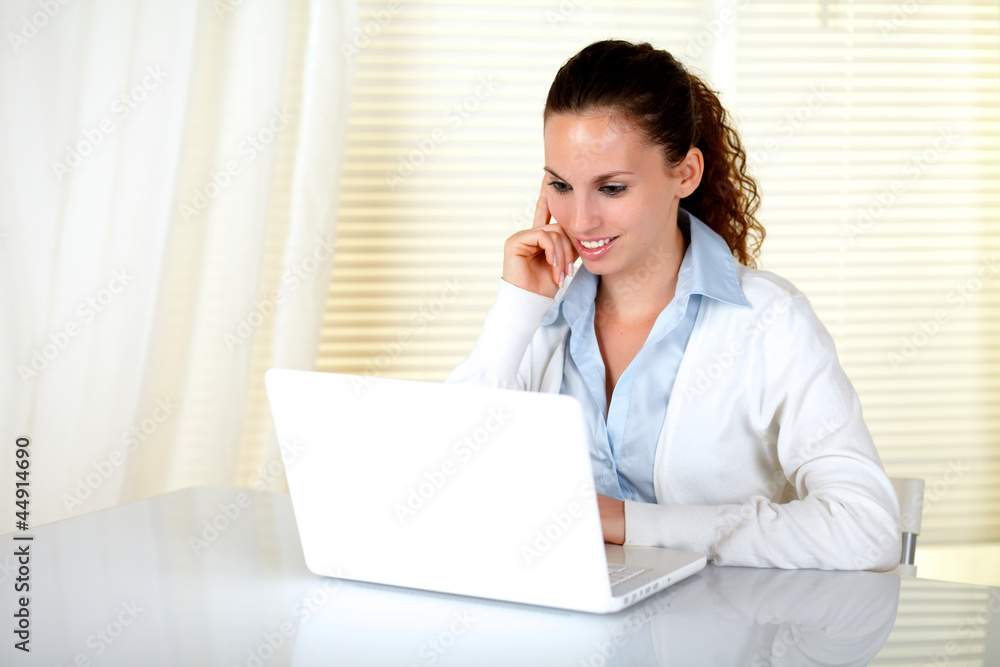 Caucasian young woman reading on laptop screen Caucasian young woman reading on laptop screen