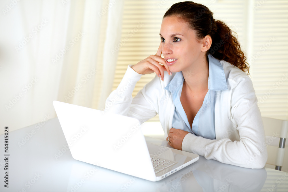 Pensive young woman in front of her laptop Pensive young woman in front of her laptop