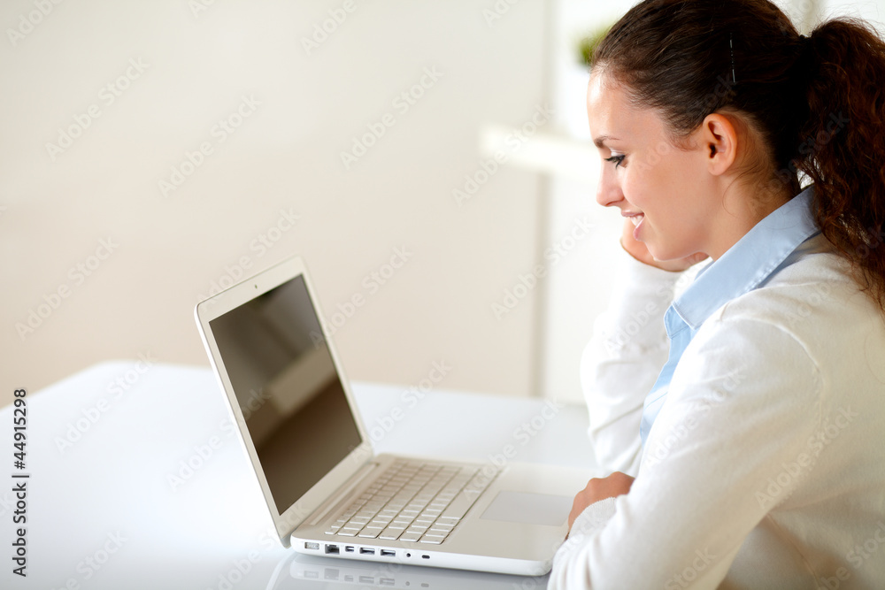 Charming young female reading on laptop screen Charming young female reading on laptop screen