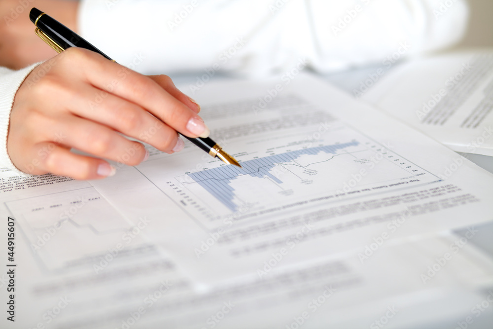 Hand of a woman pointing a graph Hand of a woman pointing a graph