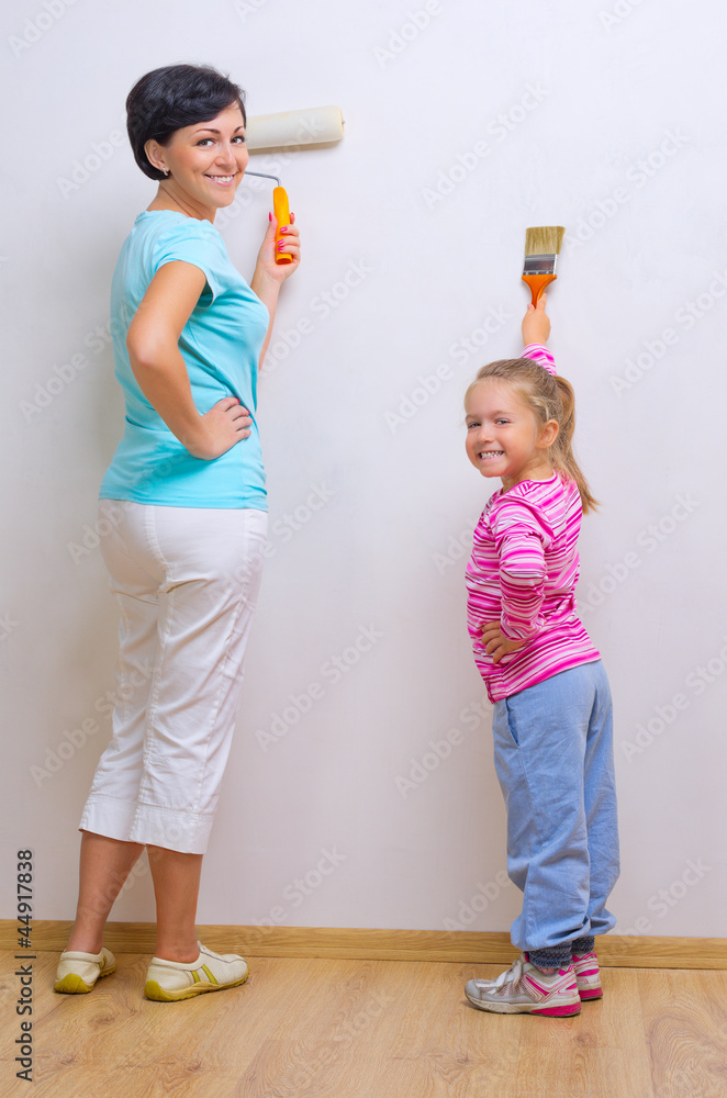 Woman and her daughter doing home repair