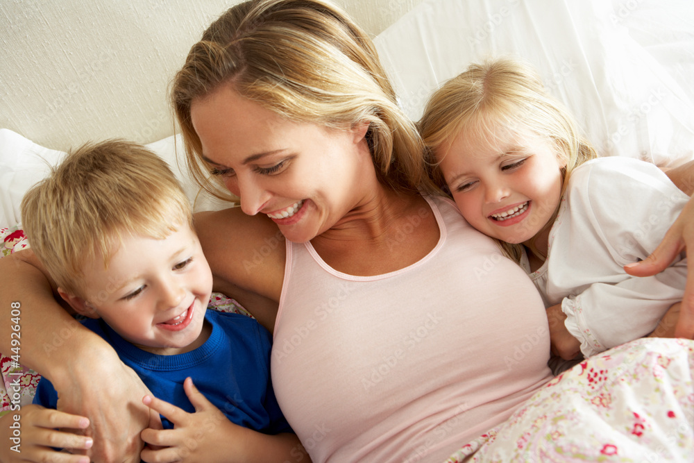 Mother And Children Relaxing Together In Bed Mother And Children Relaxing Together In Bed