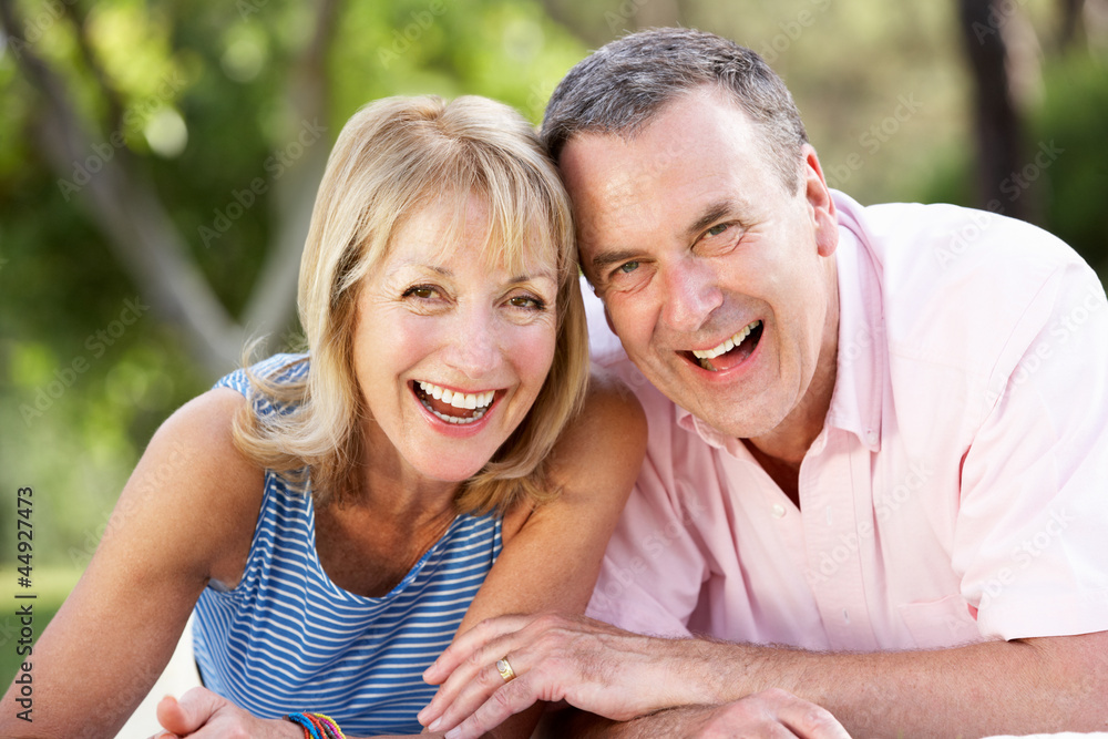 Senior Couple Relaxing In Summer Garden Senior Couple Relaxing In Summer Garden