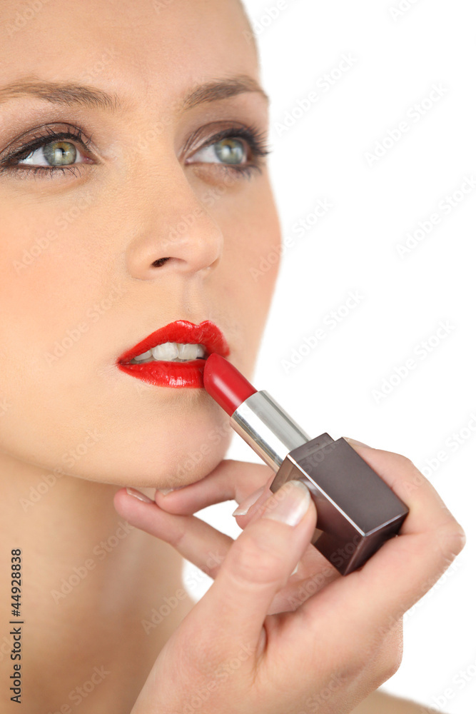 beautiful woman putting on some lipstick beautiful woman putting on some lipstick