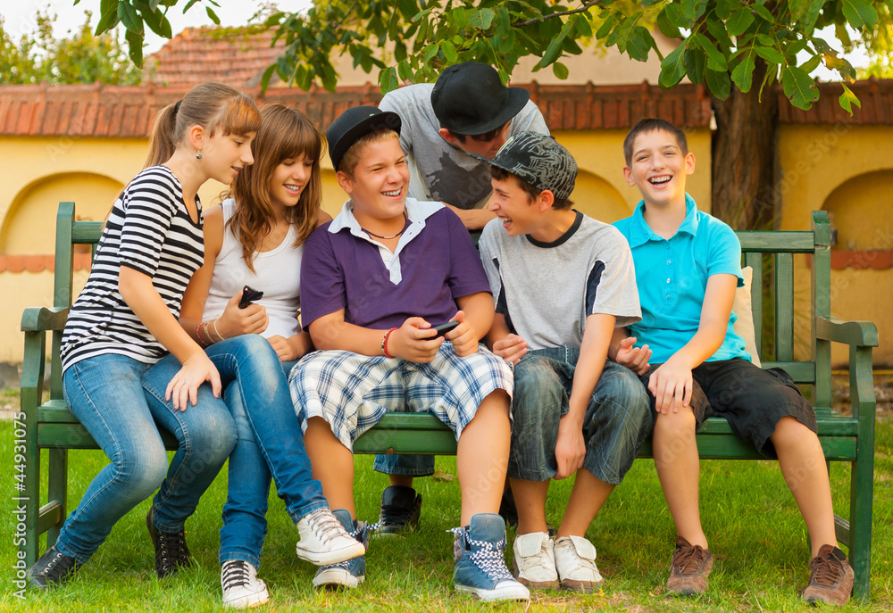 Teenage boys and girls having fun in the garden Teenage boys and girls having fun in the garden