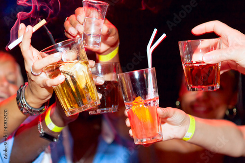 Celebration. Hands holding the glasses of cocktail and vodka mak