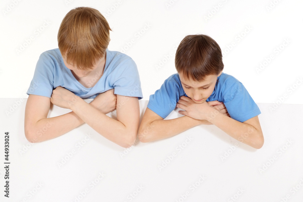 Two beautiful Caucasian guys in blue shirts are the tablet Two beautiful Caucasian guys in blue shirts are the tablet