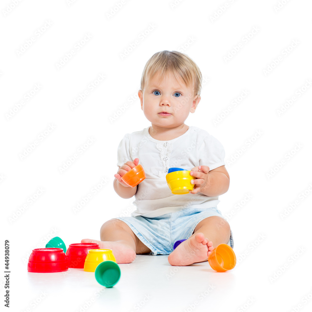 Funny little child is playing with toys while sitting on floor, Funny little child is playing with toys while sitting on floor,