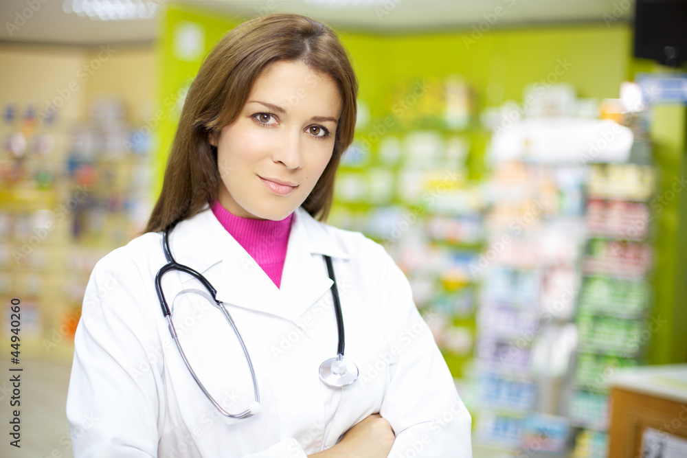 Beautiful female doctor smiling in pharmacy Beautiful female doctor smiling in pharmacy