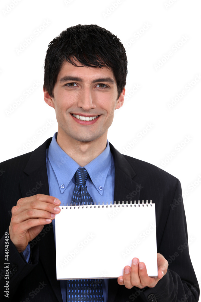Man showing blank page on a notebook Man showing blank page on a notebook