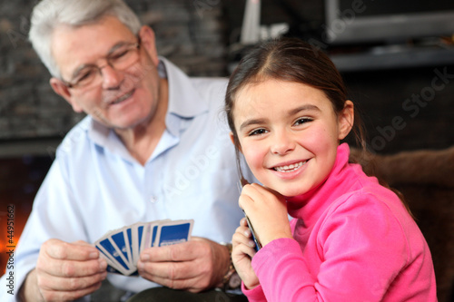 Wallpaper Mural Young girl playing cards with grandpa Torontodigital.ca