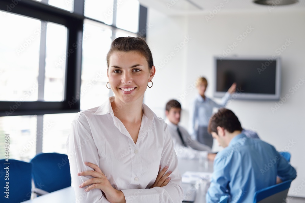 Fototapeta premium business woman with her staff in background at office
