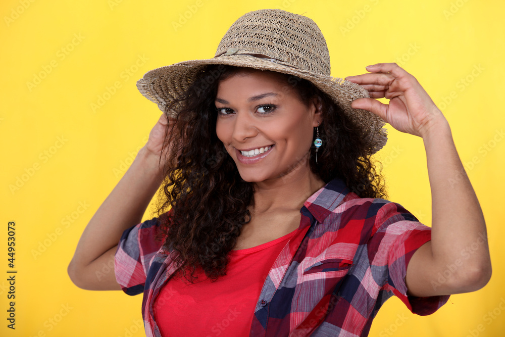 Cheerful brunette wearing straw hat