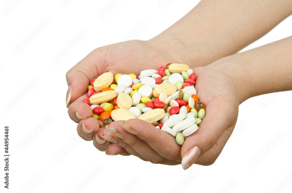 Hands holding pills on white Hands holding pills on white