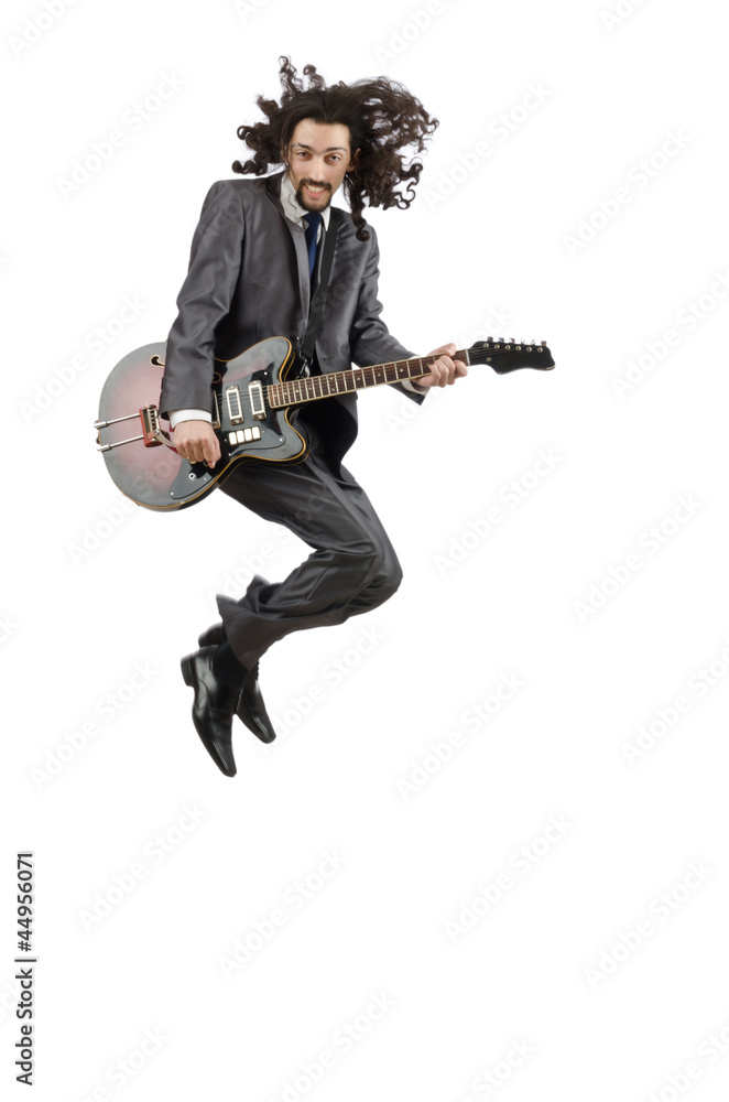 Guitar player in business suit on white