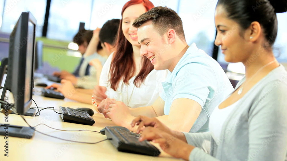 Diverse students work together in technology room Diverse students work together in technology room