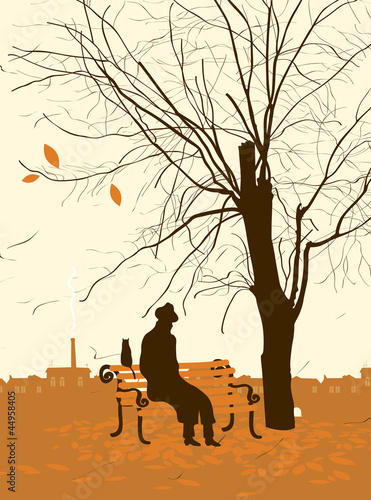 single man with a cat in the autumn tree in the park