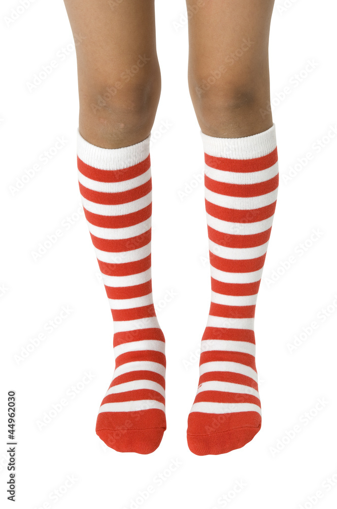 Girls legs with striped socks on white. Clipping path included.
