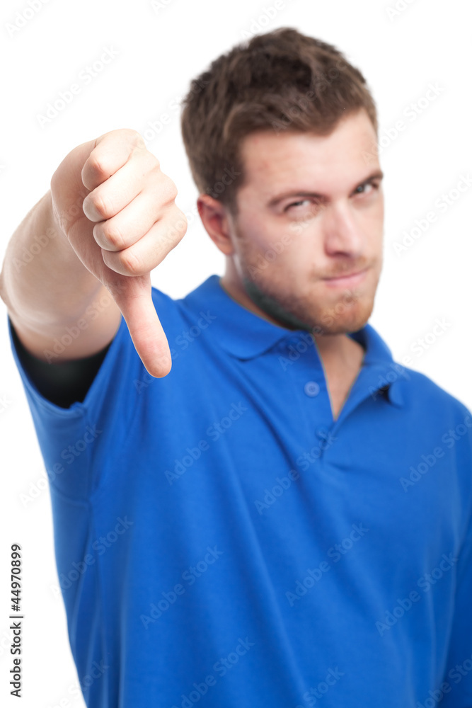 Young man gives thumb down gesture Young man gives thumb down gesture