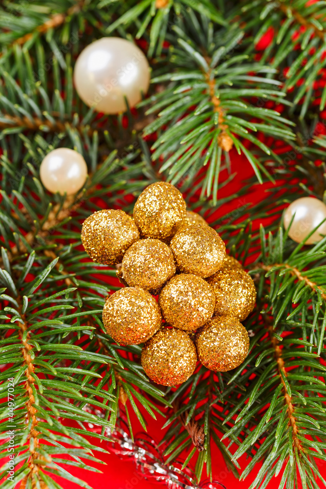 Christmas decorations and fir branch on red background Christmas decorations and fir branch on red background