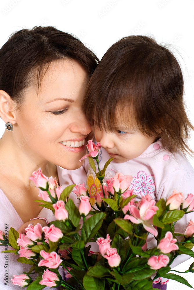 Nice Caucasian woman with a daughter and flowers Nice Caucasian woman with a daughter and flowers