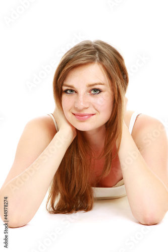 Beautiful young woman lying on the floor.