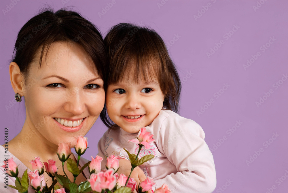 Smile Caucasian female with a daughter and flowers Smile Caucasian female with a daughter and flowers