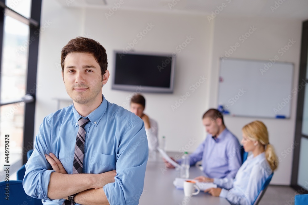 business man on a meeting in offce with colleagues in backgroun business man on a meeting in offce with colleagues in backgroun