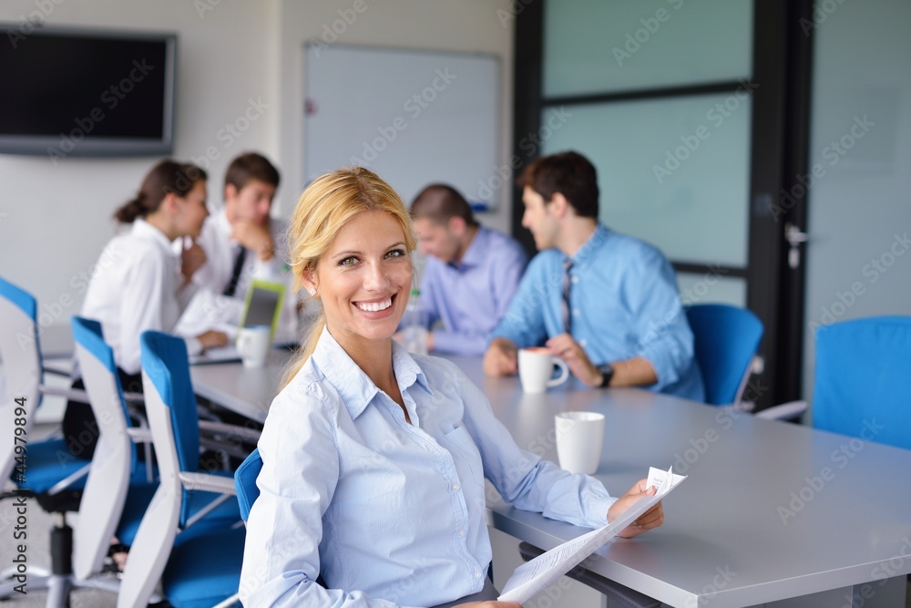 Fototapeta premium business woman with her staff in background at office