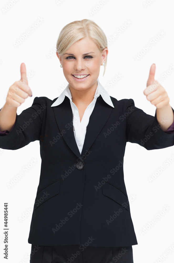 Smiling blond businesswoman thumbs-up Smiling blond businesswoman thumbs-up