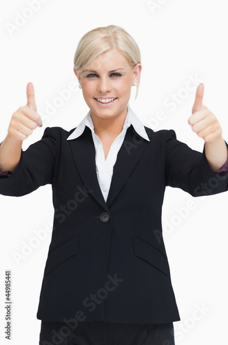 Smiling blond businesswoman thumbs-up